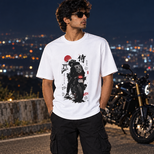 Male model wearing the white Biker's Dream graphic T-shirt at a cinematic night-road overlook with a motorcycle behind